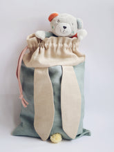 Učitaj sliku u preglednik galerije, bunny bag in sage green linen with bunny ears and fluffy tail. Great to use as slippers bag, toys bag or diaper container.