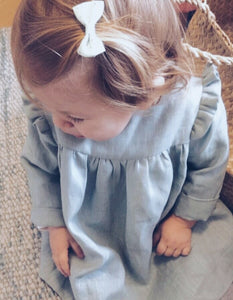 Korana linen long sleeves dress in sage green by Zekko Kids Clothes. Ruffles details on shoulders. Wooden buttons.