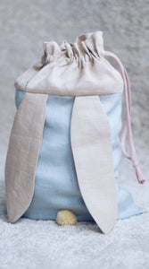 bunny bag in baby blue linen with bunny ears and fluffy tail. Great to use as slippers bag, toys bag or diaper container.